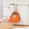 Mini bolso de concha de celebridad de internet llavero bolso de mano monedero colgante de bolsa portátil para guardar labial auriculares bolsa pequeña