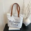Bolsa feminina casual de grande capacidade 2025 primavera/verão nova bolsa versátil de lona bolsa de ombro para o dia a dia bolsa tote simples