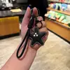 Nuevo Llavero Creativo de Imitación de Cuero con Forma de Estrella de Cinco Puntas y Colgante de Cuerda Tejida, Decoración para Mochila de Estudiante, Pequeño Juguete de Regalo