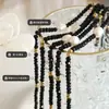 Collar de cuentas de vidrio negro con personalidad y temperamento de moda, colgante de perlas de agua dulce, joyería sexy, diseño original de nicho.