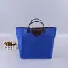 Em estoque cor sólida tecido Oxford impermeável dobrável portátil bolsa de compras portátil de viagem com zíper bolsa de armazenamento de grande capacidade