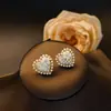 Pendientes de cristal y perla con incrustaciones de circonita y flor de amor de cobre, sentido de lujo ligero de alta gama, joyería de moda para mujer, temperamento de viajera, venta al por mayor