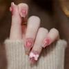 Uñas postizas nuevas color nude transparente hielo con corazón y lazo, difuminados, se pueden desmontar repetidamente y son de acabado libre, venta directa de fábrica de productos terminados.