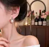 Pendientes de Botón con Perla y Lazo Estilo Pequeño Chanel para Mujer Joyería para Orejas de Viaje Versátil Simple de Gama Alta Nicho Venta al por Mayor