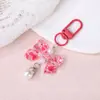 Llavero accesorio con lazo de purpurina floral y colgante de perla DIY hebilla plana de aleación charm para bolso femenino