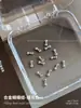 Joyas de uñas de aleación con forma de lazo exquisito tridimensional plata corbata de lazo pequeña taladro de uñas red roja explosiones decoraciones al por mayor