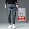 Jeans elásticos de 8/9 de largo para hombre Guangzhou Xintang, modernos y versátiles para primavera y otoño, de moda para personas bajas de 160 cm