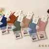 Calcetines de algodón gruesos de punto para bebé, otoño e invierno, altos, holgados, a rayas, con letras de dibujos animados, calcetines para niños, venta al por mayor, envío completo