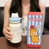 Taza aislada linda con temática de gato y compartimento para té, con cordón portátil, hecha de acero inoxidable 316, adecuada para estudiantes, y disponible para venta al por mayor y pedidos personalizados.
