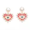 Pendientes de aleación con incrustaciones de perlas y diamantes, con temperamento de moda transfronteriza europea y americana, creativos de lujo ligero, con forma de corazón y ojo de ángel