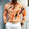 Nueva camisa de manga larga para hombre con base azul y estampado de salpicaduras naranja-amarillas, diseño audaz y llamativo, versátil para ir al trabajo
