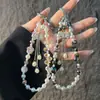 Elegante correa de cristal para teléfono móvil con forma de flor de ciruelo, con lazo tachonado de diamantes de imitación y borla, accesorio corto para bolso de muñeca