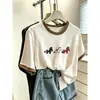 Camiseta de algodón de manga corta para mujer, con bloques de color, hombros normales y diseño de copo de nieve, de nicho y elegante, adecuada para ir al trabajo, adelgazante y versátil, un artículo popular para el verano de 2026