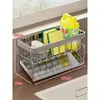 Cesta escurridora de cocina con diseño inclinado, hecha de acero inoxidable, puede sostener esponjas, estropajos y incluye un tendedero para paños de cocina. Es estable, impermeable y no requiere taladrar para su instalación