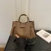 Bolso pequeño retro simple para mujer, nuevo bolso cruzado de moda 2026 para ir al trabajo, bolso de mano versátil de otoño tipo cubo