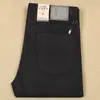 Pantalones casuales de mezclilla gruesos de poliéster y lana con textura de pelo elástico de alta gama para hombre, cálidos, de cinco bolsillos, para otoño e invierno