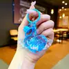 Llavero de alas en forma de corazón botella de arena movediza colgante lindo amor luminoso colgante de pareja regalo para mochila de estudiante venta al por mayor