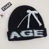 Gorro estilo coreano con lazo para mujer, nuevo modelo 2026, gorro de lana tejido con orejeras, adecuado para ciclismo, cálido, lindo y a prueba de viento
