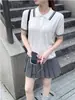 Top de punto minimalista estilo coreano, estilo universitario, manga corta, nuevo modelo de verano, adelgazante, bloques de color, versátil, elegante para mujer en blanco
