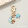 Llavero combinado de pentagrama calado y luna creciente transfronterizo, colgante de mochila de estrella y luna de esmalte colorido con cierre de langosta, accesorio pequeño
