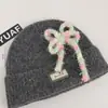Gorro de punto estilo coreano de mezcla de lana inspirado en la dopamina con un lazo, un gorro de invierno cálido y protector para las orejas para mujer, adecuado para estudiantes