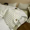 Nuevo conjunto de cuatro piezas de algodón y lino estilo botón simple de lujo ligero, estilo minimalista de Instagram, conjunto de tres piezas de hilo de rizo de algodón puro para ventas transfronterizas
