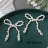 Ins Corea del Sur perla de imitación lazo corazón de melocotón diy tejido a mano clip para el pelo de cuentas accesorios para el cabello material para pendientes venta al por mayor