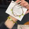Pulsera tejida a mano de trébol de cuatro hojas, estilo nuevo 2025, estilo Ins, nicho, fresca y brillante, pulsera de amistad para parejas para mujeres, verde