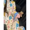 Pijama lindo de estilo coreano con estampado de dibujos animados y retazos para mujer, conjunto de ropa de estar de manga larga y pantalón largo de talla grande para principios de otoño, adecuado para usar en exteriores