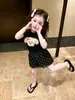 Conjunto de Verano Nuevo para Niñas 2026, Estilo Popular de Alta Venta de Este Año, Top Negro de Manga Corta con Dibujos y Shorts Delgados para Niñas