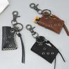Llavero colgante personalizado transfronterizo Encendedor portátil para camping al aire libre Estuche de cuero Estuche de cuero PU retro para encendedor