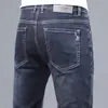 Jeans masculinos de alta qualidade para primavera e verão, corte reto, caimento slim, elástico, calça longa moderna de Guangzhou Xintang, estilo versátil de verão
