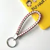 Llavero creativo llavero de cuerda de cuero cordón para llaves colgante de joyería cordón tejido fábrica de cuerda de cuero venta al por mayor