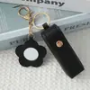 Mini llavero de lipstick portátil, bolsa redonda de cuero con espejo de maquillaje, accesorio para niñas, colgante de bolsa de espejo de maquillaje portátil
