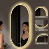 Espejo de baño inteligente ovalado en stock con lijado exterior e iluminación LED translúcida, adecuado para montaje en pared de baño y proyectos hoteleros, con opciones de personalización.