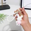 Llavero creativo de oso de amor que lleva una buena matanza corriendo con la misma muñeca de pareja llavero colgante bolso de coche colgante