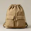 2026 Estilo Nuevo Bolsa de Lona Sencilla con Cordón Mochila para Estudiante de Escuela Primaria de Viaje Mochila Ligera Bolsa de Tela de Bolsillo Bolso de Doble Hombro