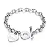 Joias de aço titânio transfronteiriças para mulheres, pulseira da moda com fecho OT e pingente de coração, pulseira de casal em formato de coração com letra em inglês