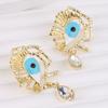 Pendientes de moda transfronteriza con forma de ojo de diablo de cristal con diamantes huecos personalizados y ojos azules exagerados que caen sobre el aceite.