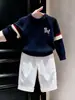Ropa Infantil Estilo Coreano 2026 Otoño/Invierno Nuevo Suéter de Punto con Bordado de Cachorro Azul Marino Conjunto de Pantalones Blancos Rectos para Niños