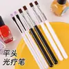 Pluma aplicadora de pegamento para decoración de uñas al por mayor transfronteriza, pluma de fototerapia de cabeza plana con cerdas de colores, pincel para decoración de uñas con mango individual negro y blanco