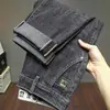 Jeans Masculino Primavera e Outono 2026 Novo Stretch Guangzhou Xintang Marca Tendência de Alta Qualidade Calças Slim Fit de Corte Reto