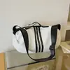 A bolsa popular para o trabalho deste ano para mulheres 2026 nova bolsa tote bolsa de ombro único transversal bolsa casual esportiva grande capacidade moderna