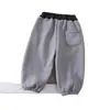 Nuevos pantalones de chándal de color liso con forro polar para niños de otoño e invierno, lindo estampado de cachorro, ajuste holgado tipo jogger para niños y niñas, tendencia al por mayor