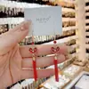 Brincos longos e elegantes de borla de fortuna festiva de ano novo em estilo chinês, design de nicho feminino, brincos de gancho de orelha com fecho de paz