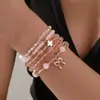 Novo bracelete de verão europeu e americano estilo férias de praia com estrela-do-mar, concha, pérola, bracelete de cordão trançado elástico para mulheres, atacado