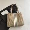 Bolso tote de lona de gran capacidad estilo casual coreano 2026 para mujer, nuevo bolso de mano de moda para estudiantes, adecuado para la escuela y el trabajo