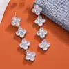Pendientes de lujo ligeros de alta gama con temperamento de hierba de la suerte, aguja de plata s925, borla larga de circonita, pendientes de flores de viajero de moda
