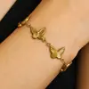 Pulseira de coração com borboleta e cruz estilo europeu e americano, feita de aço inoxidável, exclusiva para e-commerce transfronteiriço, e garantida para não desbotar - um acessório moderno