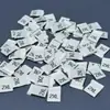 Marca de tejido pliegue marca de tejido marca de número talla general de ropa talla de accesorios etiqueta de tela directo de fábrica comercio exterior se puede fijar